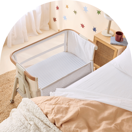 Bedside bassinet beside a bed