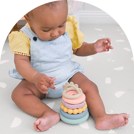 Baby playing with stacking toys