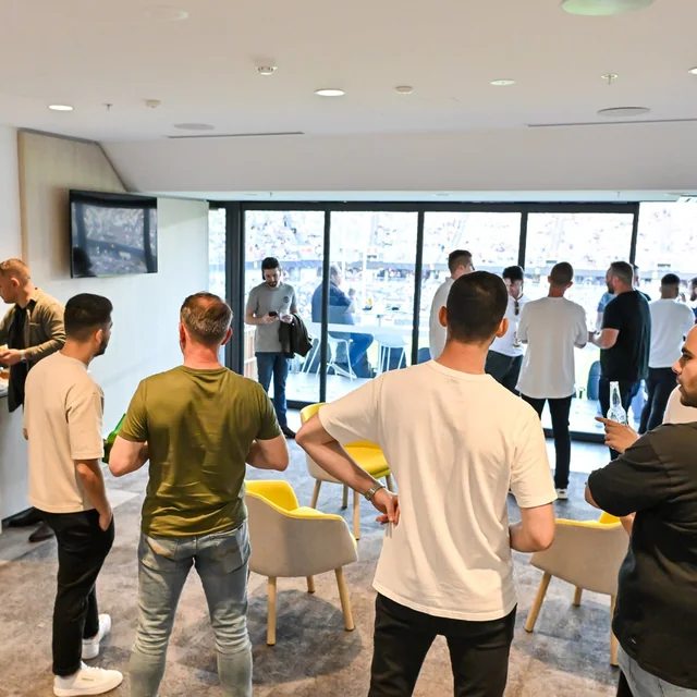 Friends gathered in a private suite overlooking the field